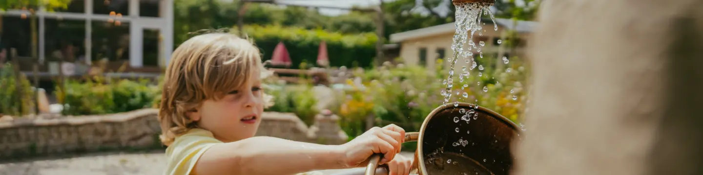 spelen bij de fontein met water en zand jongetje